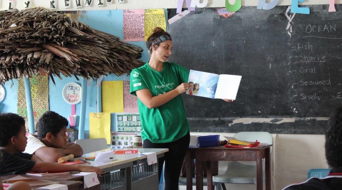 A Projects Abroad volunteer in Samoa hosts a lesson for a local classroom A community volunteer for teenagers in Samoa hosts a lesson